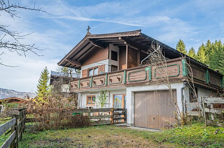 Attractive vacation home Haus Maria in Oberndorf, Tyrol, surrounded by snow and serene nature.