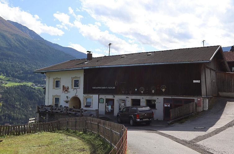 Authentic Gmarerhof vacation accommodation in Grins, Tyrol, with picturesque mountain scenery.