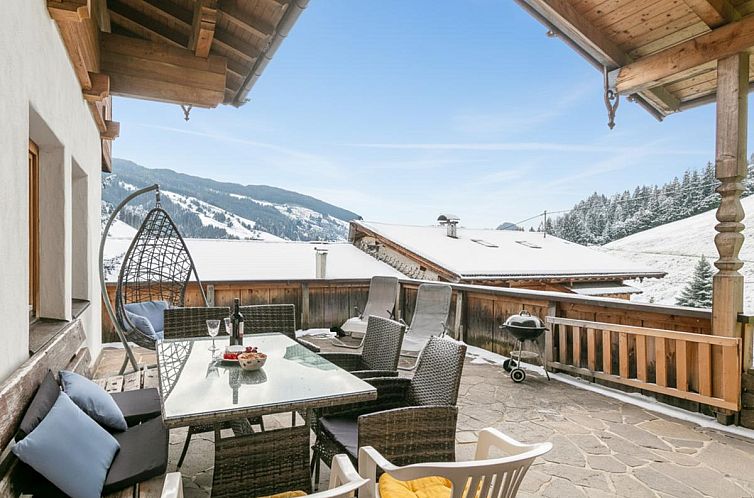 Explore the rustic charm of Almruhe Alpbach in Tyrol, Austria, with stunning views from the balcony of this vacation home.