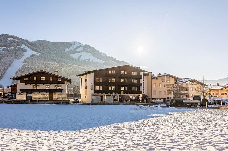 Cozy accommodation Brixen Alpin Living Top 1 und 2 und 3 in snowy Brixen im Thale, Tyrol, with beautiful mountain scenery.
