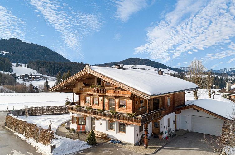 Cozy vacation home Haus Sarah in Hopfgarten im Brixental, Tyrol, with stunning views of the snow-covered Alps.