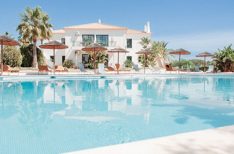 Relax in the elegant Casa Velha apartments, Santa Eulalia, Algarve, surrounded by a stunning pool and lush nature.