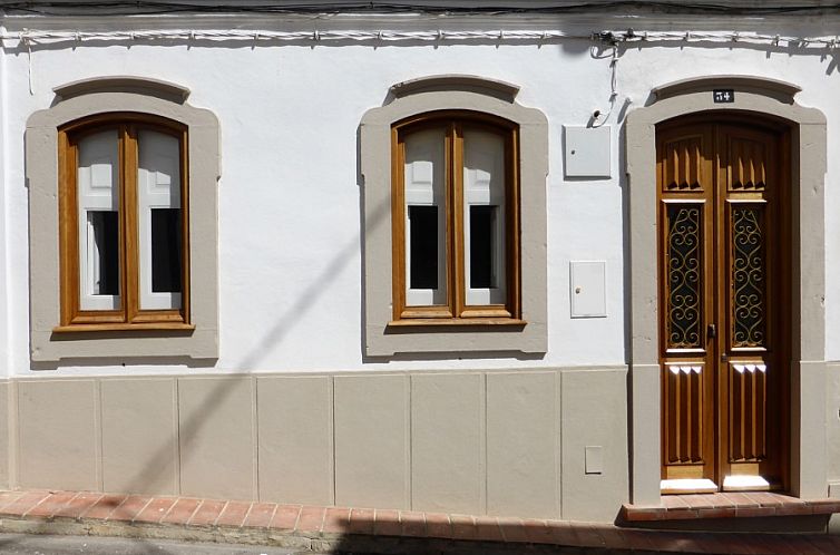 Authentic front of Casa Levante, vacation home in Fuzeta, Algarve, Portugal, with classic wooden details.