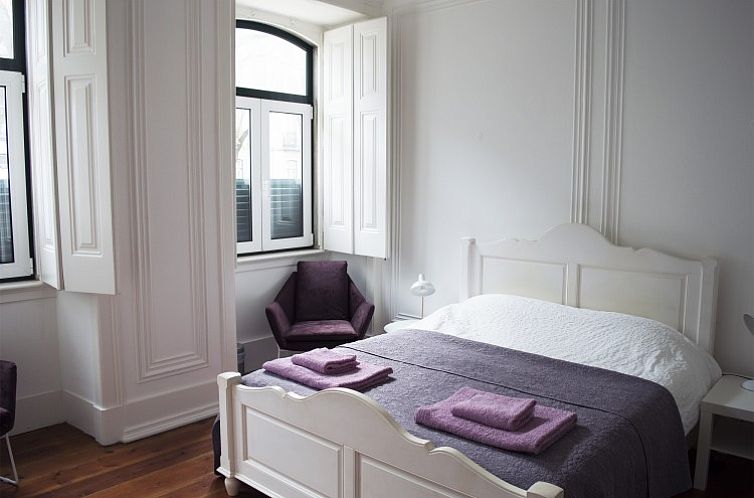 Comfortable bedroom in Happy Stay in Lisboa, Portugal, with elegant interiors and inviting atmosphere.