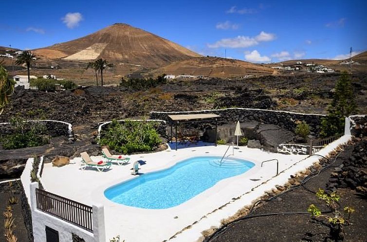 Relax by the pool at Villa Penas Blancas, a vacation rental in Macher, Canary Islands, with stunning mountain views.