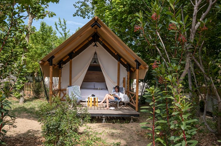 Erleben Sie Luxus im Glamping Couple Safarizelt in Santa Cristina d'Aro an der Costa Brava mit einer einladenden Terrasse in gruener Umgebung.
