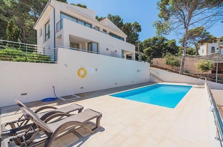 Relax by the pool at Apartments Cala Molins, a serene vacation accommodation in Cala San Vincente, Mallorca.