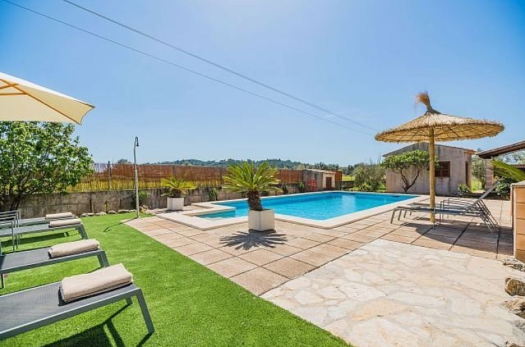 Soak up the sun at Villa Magdalena's pool in Puerto Pollensa, Mallorca, an idyllic vacation home with comfortable loungers.