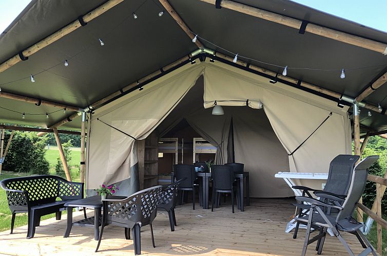 Relax on the inviting terrace of the Safari Tent in Sluknov, Bohemia, a perfect glamping destination in the Czech Republic.