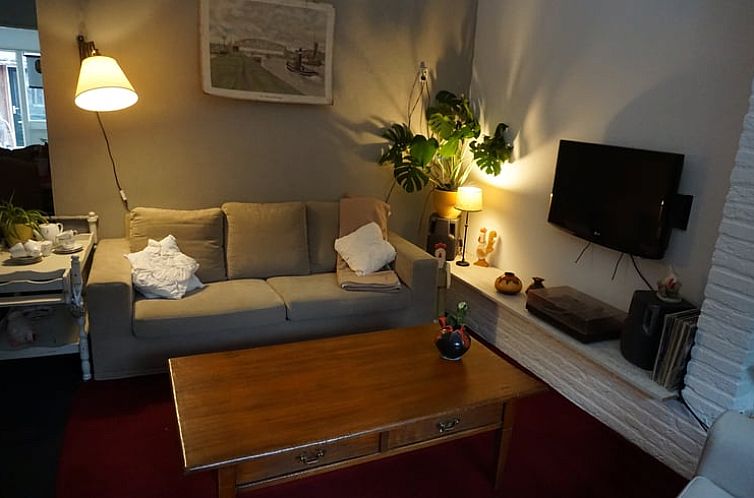 Cozy living room in Holiday Home in Odoornerveen, Southeast Drenthe with comfortable sofa and TV.