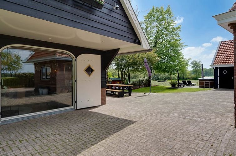 Porch of Cottage in Fluitenberg overlooking green nature in Southwest Drenthe.