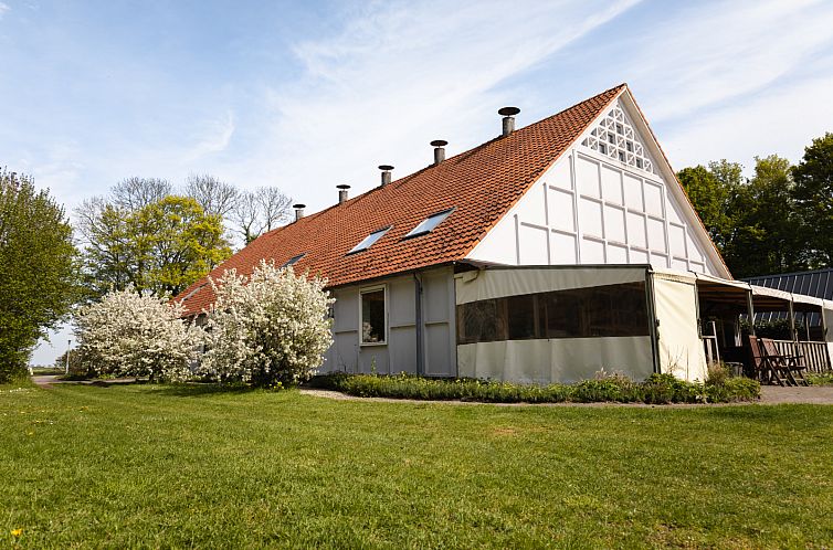 OV152 vacation home in Marknesse with traditional architecture and flowering garden in Flevoland