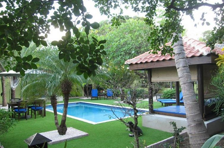 Enjoy the serene garden and pool at Villa L'Orangerie Apartments, Julianadorp, Curacao, a tropical paradise.