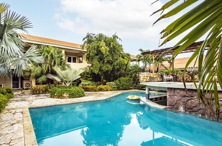 Geniet van de serene ambiance bij het zwembad van Cocobana 18, een luxe vakantieappartement in Jan Thiel, Curacao.