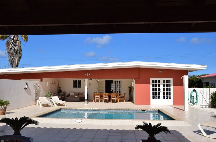 Relax at Villa San Miguel, a beautiful vacation home with an inviting pool in North, Aruba.