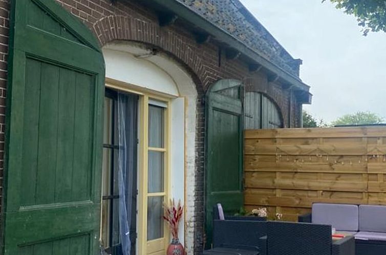 Charming exterior of Holiday Home in Tricht, Gelderland, with inviting terrace.