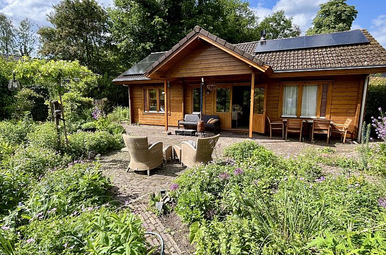 Vacation home DG1836 in Winterswijk, Achterhoek with an inviting terrace surrounded by lush nature in Gelderland.