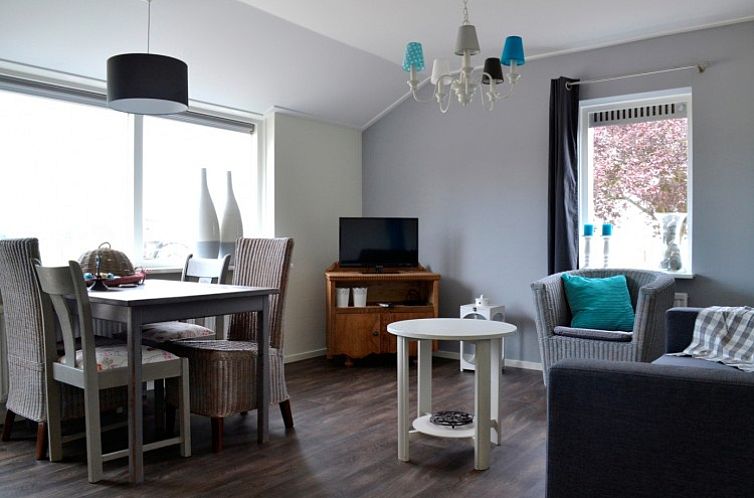 Cozy living room in 't Haller vacation home in Vorden, Achterhoek, with modern furnishings and lots of natural light.