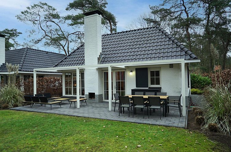 Enjoy peace and quiet on the terrace of Villa Hottub 8, a luxury vacation home in Beekbergen, Veluwe, surrounded by beautiful nature.