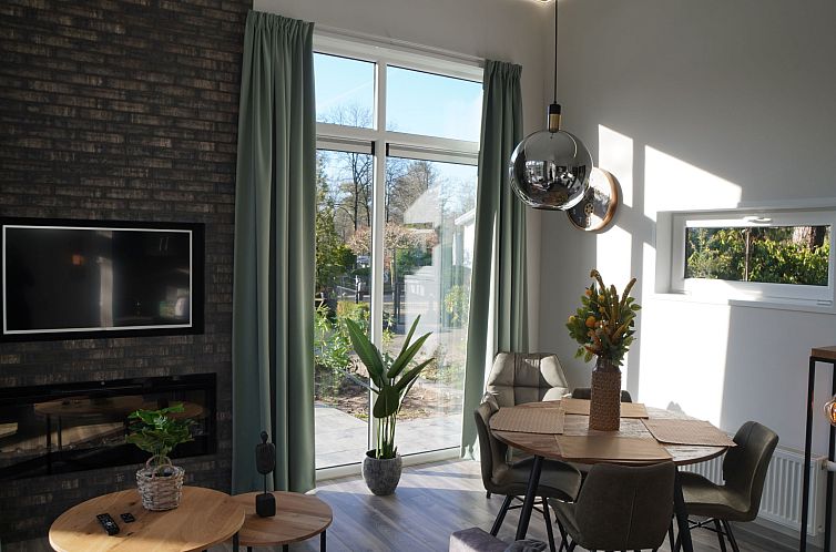 Cozy living room in Holiday Home Tiny House, Hoenderloo, Veluwe with lots of natural light.