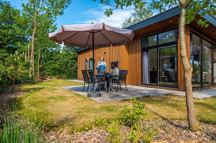 Enjoy the sunny veranda at Pavilion 4, a vacation home in Otterlo, Veluwe, surrounded by green nature and tranquility.