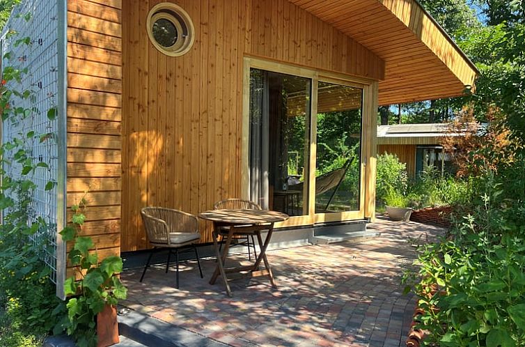 Enjoy the serene veranda at Holiday Home in Otterlo, located in the beautiful Veluwe, Gelderland.