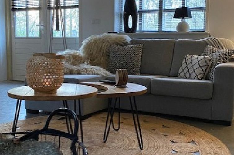 Cozy living room in WedderheideHoeve vacation home, Wedde, with comfortable sofa and natural light, Southeast Groningen.