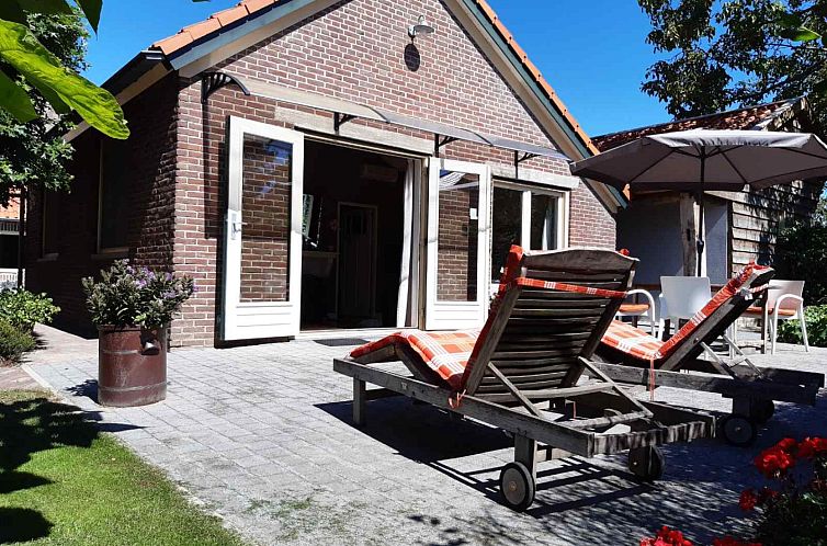 Enjoy the sunny veranda at vacation home L202 in Nederweert, Central Limburg. Relax on comfortable deck chairs.