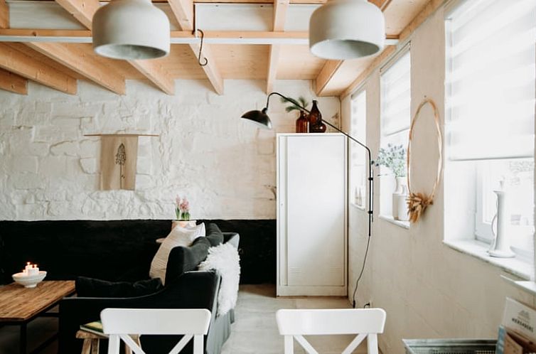 Cozy living room in Holiday Home in Scheulder, South Limburg with comfortable seating area and natural light.