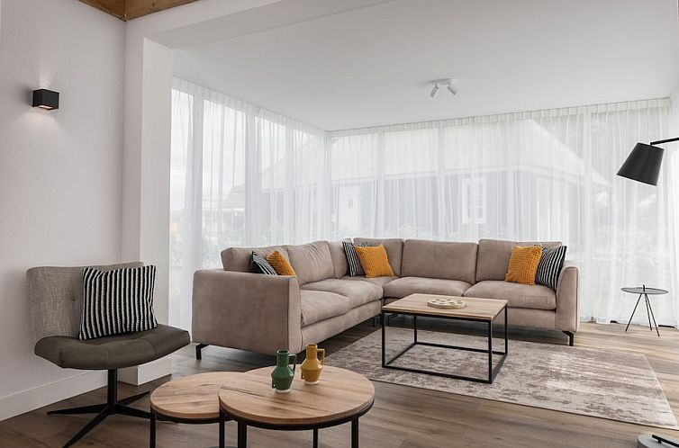 Cozy living room in Villa 6C, a vacation home in Someren, De Peel, North Brabant with comfortable seating area.