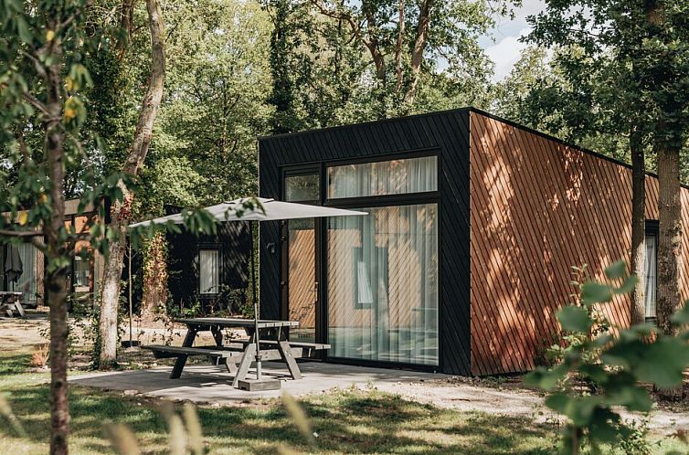 Enjoy the serenity of nature around Forest Cabin 6, a modern vacation home in Schaijk, Northeast Brabant, with spacious terrace and wooded surroundings.