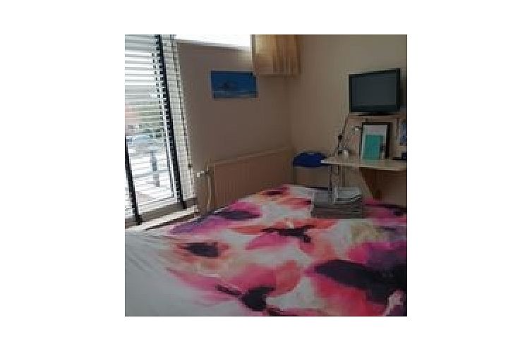 Gezellige slaapkamer met kleurrijk beddengoed bij SleepInnCallantsoog, bed and breakfast in Callantsoog aan de Noordzeekust.