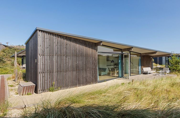 Sea House Special vacation home in Overveen, North Sea coast, surrounded by dunes with modern terrace and glass facade.