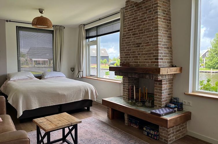 Cozy bedroom with fireplace in Holiday Home in Kalenberg, Northwest Overijssel.