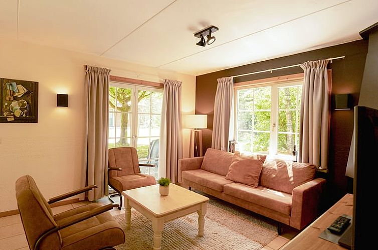 Gezellige woonkamer in Vakantiehuisje in Soest, Utrecht met veel lichtinval en comfortabele zitruimte.