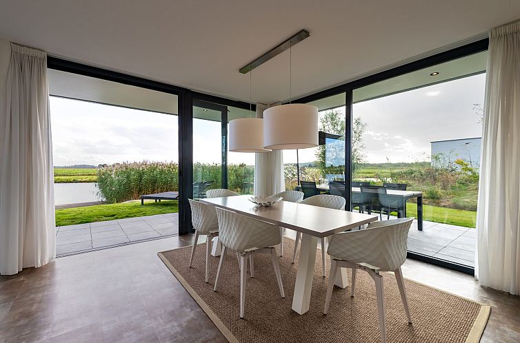 Dining area in Waterline 28, a vacation home in Kamperland, North Beveland, Zeeland with views of nature.