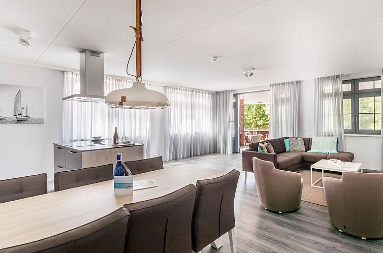 Spacious interior of Van Ghent Luxe Wellness 6 apartment in Koudekerke, Walcheren, with modern kitchen and comfortable sitting area.