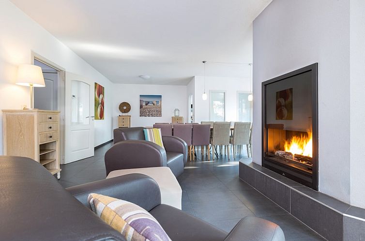 Cozy living room with fireplace in Family Villa 14, a vacation home in Ouddorp, Goeree-Overflakkee, South Holland.