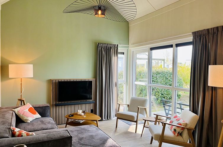 Cozy living room of Strandhuis Over De Dam in Ouddorp, vacation home with lots of light and modern decor in South Holland.