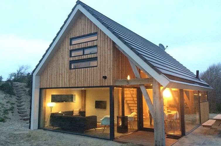 Vacation home in Ouddorp with modern wooden facade, located on Goeree-Overflakkee in South Holland, offers a cozy indoor space.