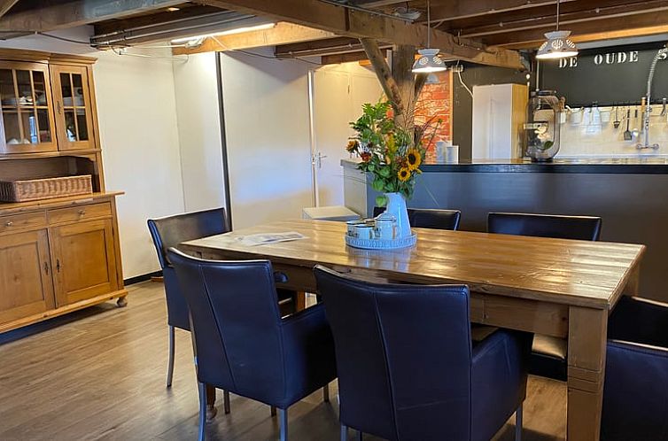 Cozy dining room in Holiday cottage in Leimuiden, Green Heart, South Holland with wooden table and leather chairs.